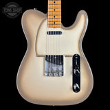 A classic Fender Telecaster electric guitar in a cream-to-brown sunburst finish, featuring a maple neck, chrome hardware, and a black control plate, shown against a solid black background with a Tone Shop watermark.