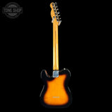 A classic Fender Telecaster electric guitar shown from the back, featuring a sunburst finish that transitions from bright orange in the center to black around the edges, set against a solid black background.