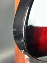 Close-up of a black rim with reflective surface on a wooden surface
