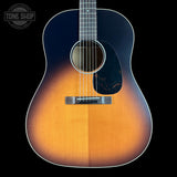 Acoustic guitar with a two-tone finish on a black background, featuring the Tone Shop logo.