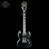 Black electric guitar on a black background with 'Tone Shop' logo.
