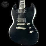 Black electric guitar with a 'Tone Shop' logo in the corner