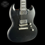 Black electric guitar with a 'Tone Shop' logo in the corner