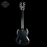 Guitar body with headstock on a black background, featuring the Tone Shop logo.