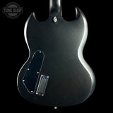 Back view of a black electric guitar with 'Tone Shop' logo.