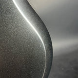 Close-up of a textured gray surface with a blurred background