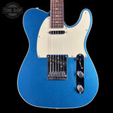 Blue electric guitar with a white pickguard on a black background, featuring the Tone Shop logo.