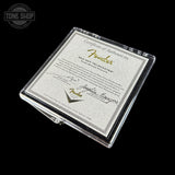 Fender certificate of authenticity in a clear protective case on a black background