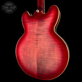 Red electric guitar body on a black background with 'Tone Shop' logo.