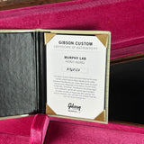 A Gibson Custom Certificate of Authenticity insert for a Murphy Lab Heavy Aging sample, displayed inside an open magenta velvet Gibson case.