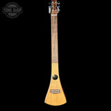 A natural wood soprano ukulele shown vertically against a solid black background, with a Tone Shop watermark in the top-left corner.