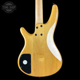 Wooden electric guitar body with a white pickguard on a black background, featuring 'Tone Shop' branding.