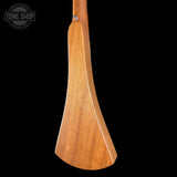 Close-up of the back of a wooden paddle blade, showing the natural wood grain and a white edge gloss, set against a solid black background with a Tone Shop watermark in the top left.