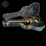 Gibson ES-335 guitar in a black case with 'Tone Shop' logo.