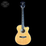 A natural wood cutaway acoustic guitar shown from the front against a solid black background, with a Tone Shop watermark in the top-left corner.