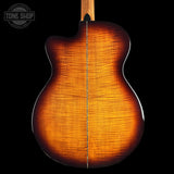 Close-up of the back of an acoustic guitar showing a vibrant sunburst finish with prominent flamed maple wood grain, set against a solid black background.