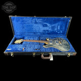 Guitar in a blue case with 'Tone Shop' logo in the corner