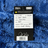 PRS Guitars label on a blue textured background