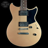A gold-finish electric guitar with a black pickguard and chrome hardware, shown against a solid black background with a Tone Shop watermark in the top-left corner.