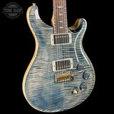 Blue electric guitar with a black background