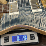 Guitar on a digital scale displaying weight