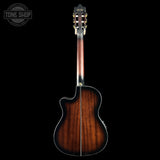 A back view of a Ayler acoustic guitar with a rich, dark brown sunburst wood finish, shown against a solid black background with a Tone Shop watermark in the top left corner.
