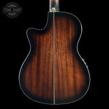 The back of an acoustic guitar with a rich dark brown sunburst wood finish, featuring a cutaway body shape and a white binding edge, shown against a solid black background.