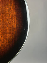 Close-up detail of a curved wooden object, showing a glossy dark brown wood grain surface with a silver metallic edge against a light gray background.