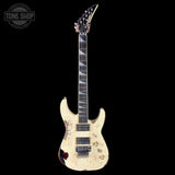 Distressed electric guitar with a visible brand logo on a white background