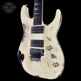 Distressed electric guitar with a visible brand logo in the corner