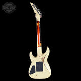 White electric guitar with a flame pattern on a black background, featuring 'Tone Shop' logo.