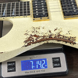 Guitar on a digital scale displaying weight, with a cracked white finish.