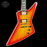 Electric guitar with a sunburst finish on a black background, featuring the Tone Shop logo.