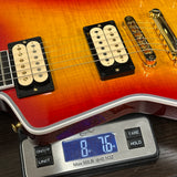 Electric guitar on a digital scale displaying weight