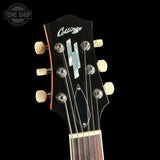 Collings guitar headstock with tuning pegs on a black background