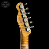 Guitar headstock with tuning pegs on a black background, featuring the Tone Shop logo.