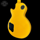 Yellow electric guitar on a black background with 'Tone Shop' logo.