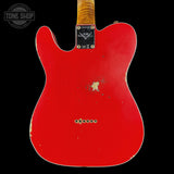 Red electric guitar with visible wear on a black background, featuring the Fender logo.