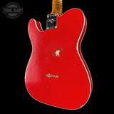 Red electric guitar with visible wear on a black background, featuring 'Tone Shop' logo.