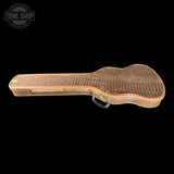 A vintage guitar case with a crocodile-embossed pattern in brown and tan, featuring a black handle, shown against a solid black background with a Tone Shop logo in the top-left corner.