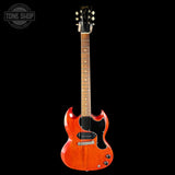 An electric guitar with a vibrant orange-red sunburst finish, shown vertically against a solid black background. The brand 'Ricken' is visible on the headstock, and a 'Tone Shop' watermark is in the top-left corner.