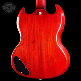 The back of a classic electric guitar with a glossy red cherry finish, featuring a black pickguard and a silver tailpiece, shown against a solid black background.