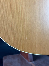 Close-up of a textured beige surface with a blurred object in the foreground