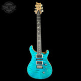 Turquoise electric guitar on a black background with 'Tone Shop' logo.