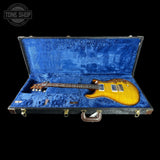 Guitar in a blue case with 'Tone Shop' logo in the corner