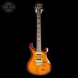 Electric guitar with a sunburst finish on a black background, featuring the Tone Shop logo.