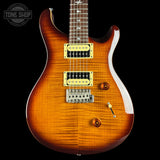 Electric guitar with a sunburst finish on a black background, featuring the Tone Shop logo.