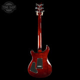 Red electric guitar on a black background with 'Tone Shop' logo.