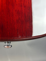 Close-up of a wooden object with a metallic knob on a white background