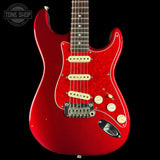 Red electric guitar with a black background